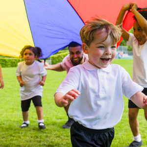 Kids under a parachute