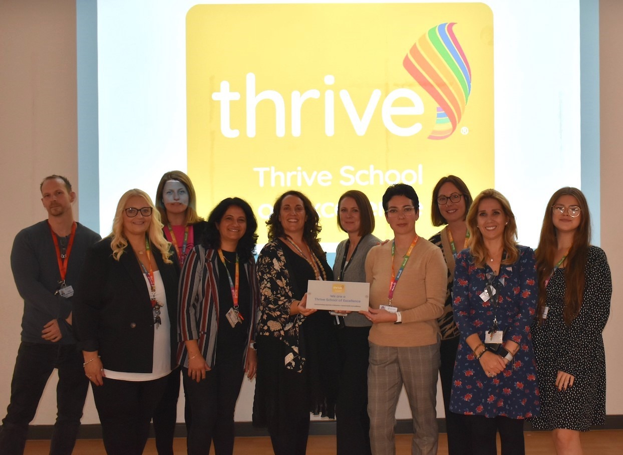 Staff at Churchward School receiving their Thrive School of Excellence award